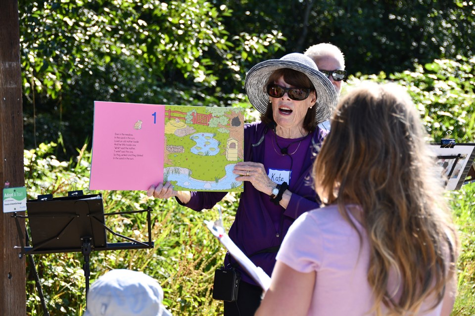 Kate Smith and Bill Marshall of Port Coquitlam sing songs and tell stories about Mother Earth before the hike begins at Deboville Slough in Coquitlam.