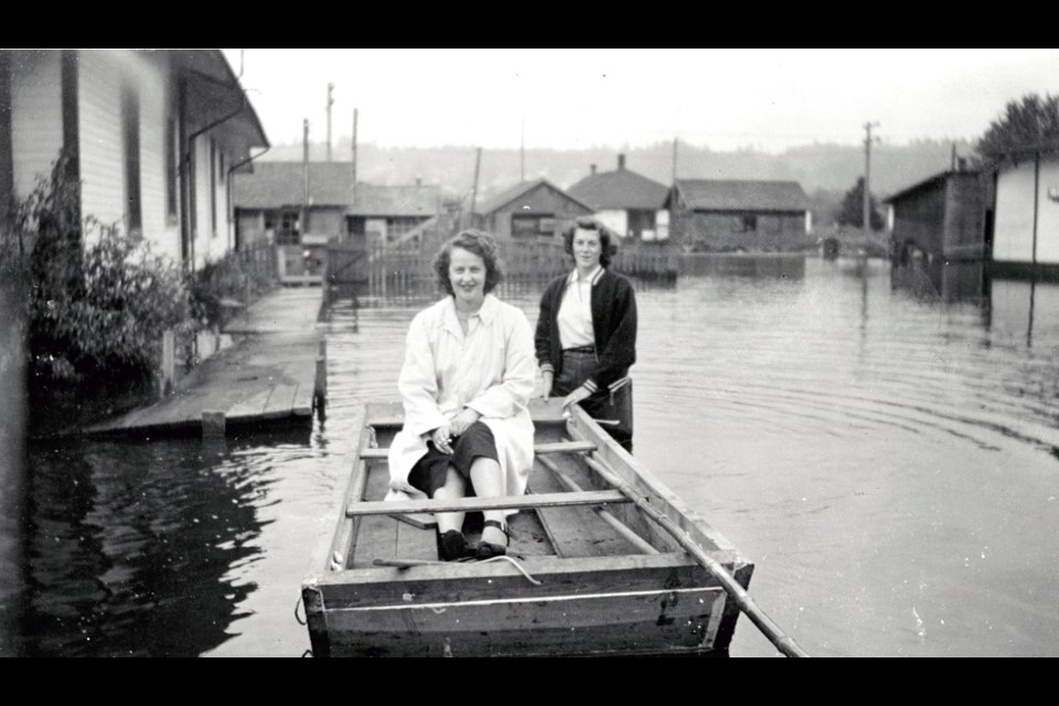 Kay Martin and Rosa Marie Crandell in a makeshift boat in Coquitlam, during the flood of 1948.