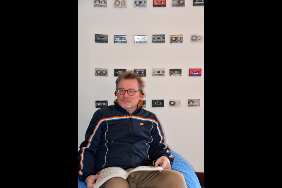 Markus Fahrner, the exhibits manager for Coquitlam Heritage, in the third bedroom at Mackin House in Coquitlam. The room has been transformed into an 80s media hub.