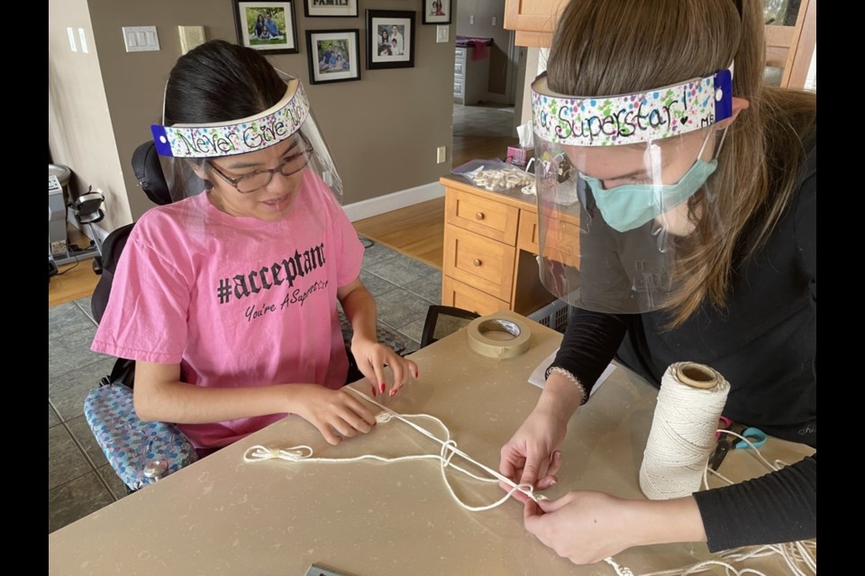 Maliyah Chung works with her partner Maya to create jewellery for their Etsy store. Every month, the two are giving a portion of the proceeds to a new charity in what Chung describes as a distraction from not being able to go to school.