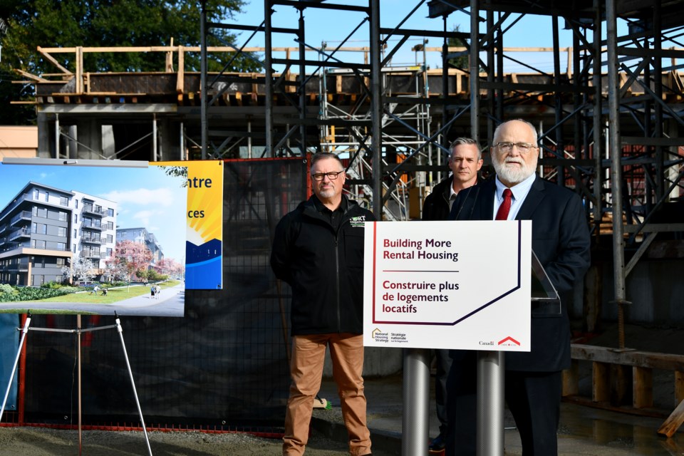 Coquitlam–Port Coquitlam MP Ron McKinnon speaks at a news conference in front of Westminster Junction in Port Coquitlam, with PoCo Coun. Glenn Pollock and Stephen Bennett, CEO of the Affordable Housing Societies, behind him.