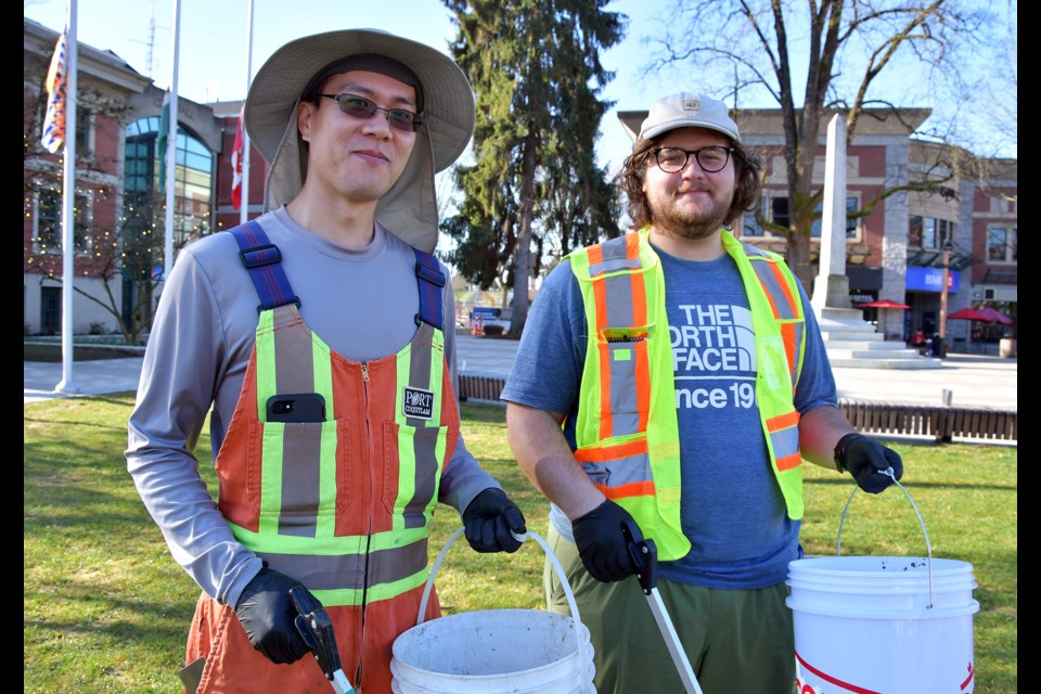 Richard Chong and Gideon Vanderheever with the City of Port Coquitlam’s public works team pick up litter around city hall on Monday, March 18, as part of the municipal spring litter blitz.