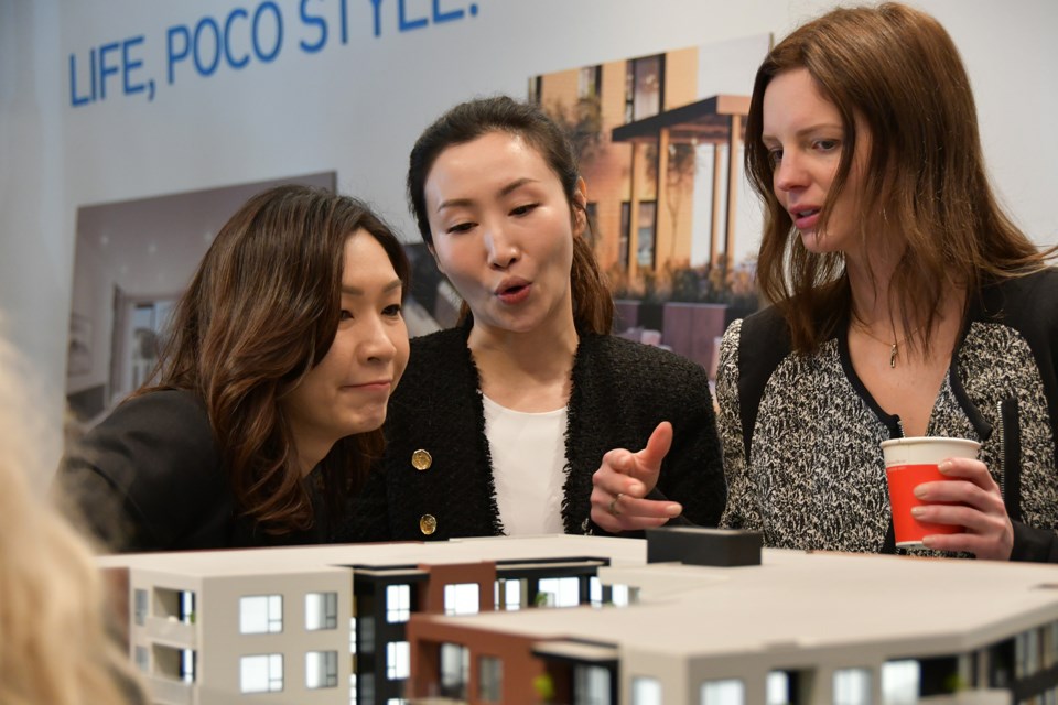 Officials with the Porthaven project admire the building design, at the presentation centre on Shaughnessy Street on March 12, 2024.