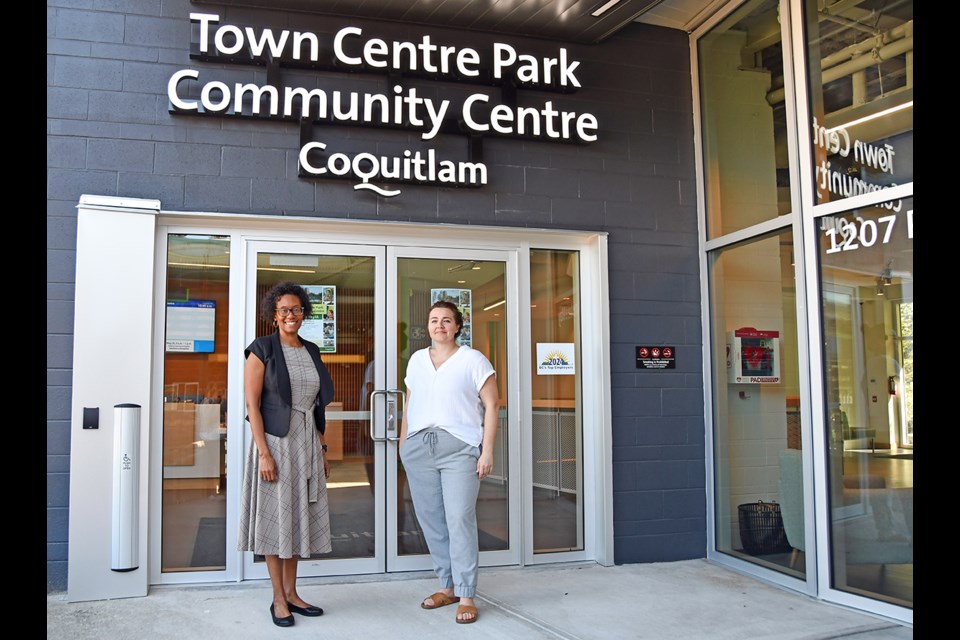 Coquitlam city staff Karen Basi and Tara Berdej outside the Town Centre Park Community Centre entrance.