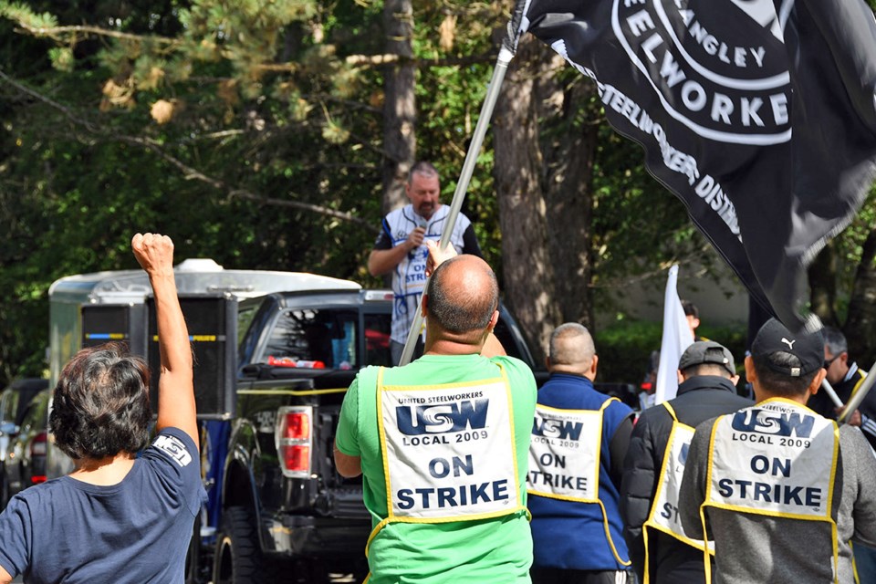 Union workers strike outside their company, Uni-Select, Bumper to Bumper, during a lunchtime rally on Sept. 18, 2024.