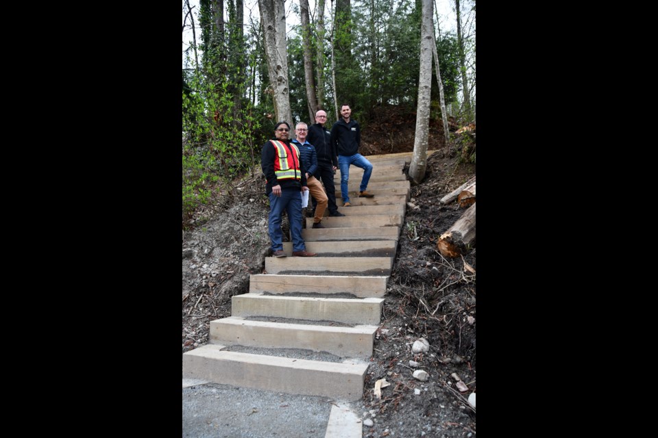 Joshua Frederick, Port Coquitlam's director of engineering and public works, with Mike Por, parks supervisor, Mitchell Guest, parks manager, and Mayor Brad West, on the new timber stairs off Shaughnessy Street.
