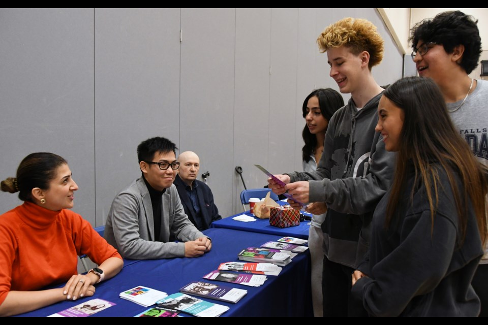 Pinetree Secondary students get career tips from officials with the WorkBC Centre in Coquitlam at a high school hiring fair on Oct. 11, 2023.