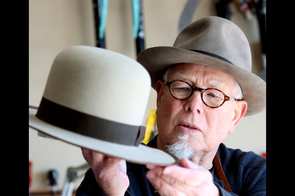 Robert Gault shows off one one of the custom fedora hats he makes in the garage of his Port Coquitlam home.