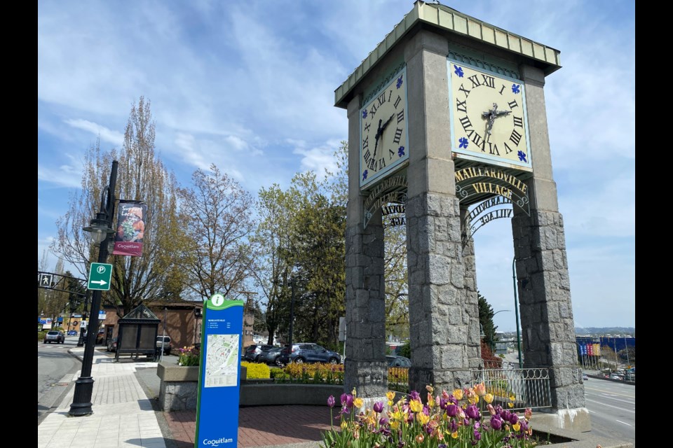 The clock and wayfaring sign marking the historic Maillardville Village at the corner of Brunette Avenue and Lougheed Highway.
