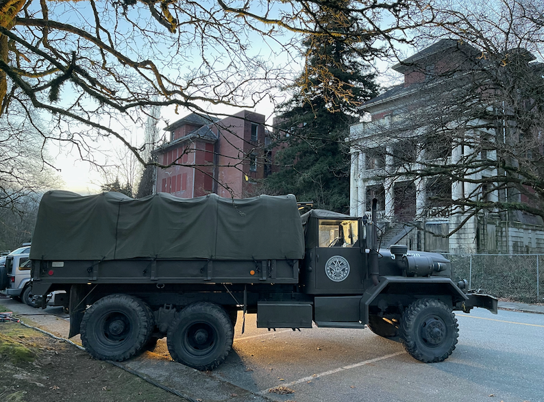 Military vehicles are used as props outside Centre Lawn at səmiq̓wəʔelə, formerly the Riverview Hospital.