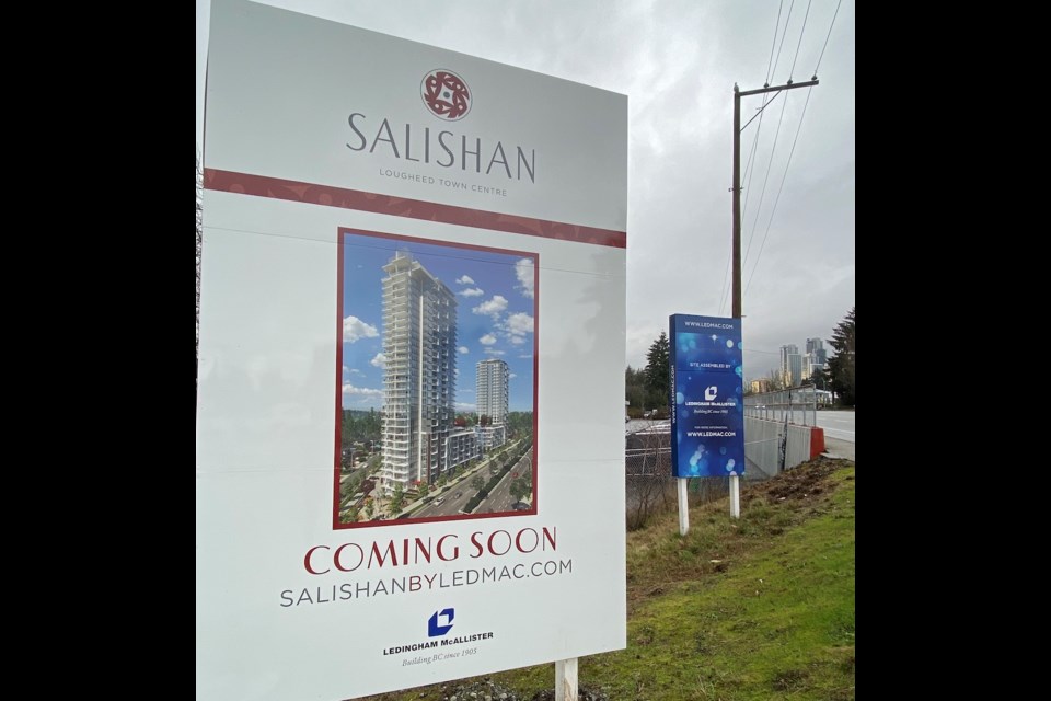 Signs promoting the Salishan, the first of two towers to be built at the corner of Lougheed Highway and Alderson Avenue.