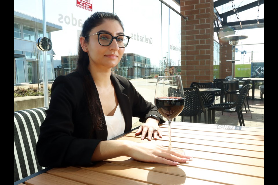 Tanpreet Sandhu, the general manager of Grelhados Grill and Bar restaurant in Port Coquitlam takes a break on the deserted patio. The restaurant's owner, Peter Sandhu, said the establishment was just finding its feet when new public health restrictions closed its dining room.