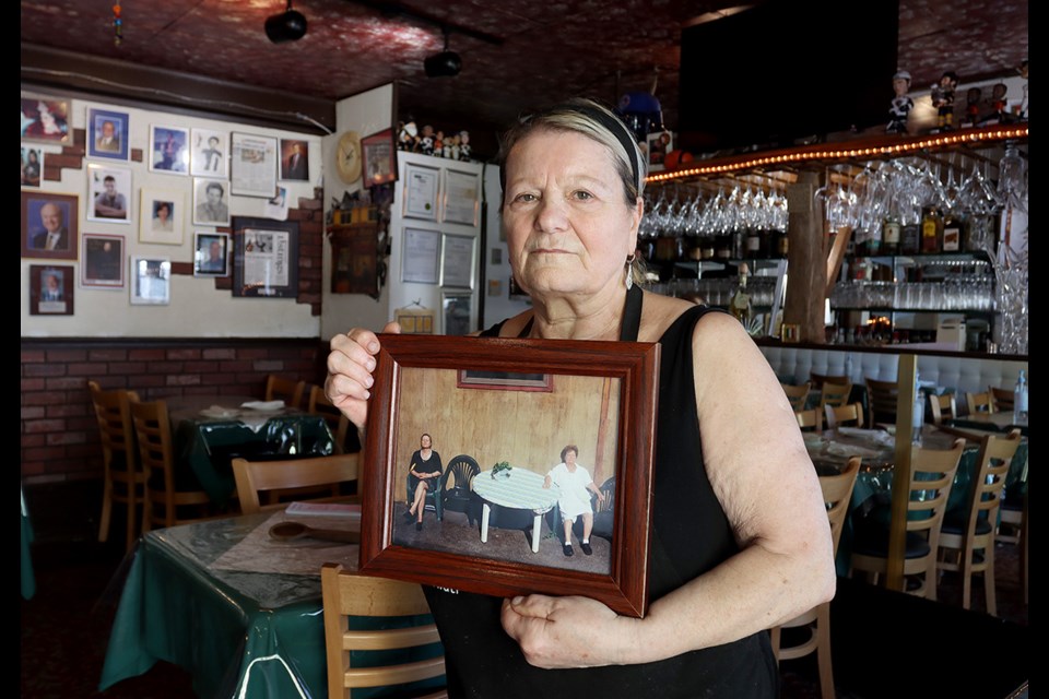 Rosa Gabrielli holds a photo of herself and her mother, Anna, with whom she started Rosa's Cucina Italiana on Port Moody's Clarke Street 22 years ago. Gabrielli is retiring at the end of August and closing her restaurant.