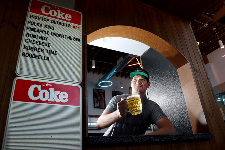 Travis McLean, the marketing manager for Parkside Brewing, checks out the snack window at the new Rewind Brewing on Port Moody's Brewers Row that will transport visitors back to the 1980s and early 90s.