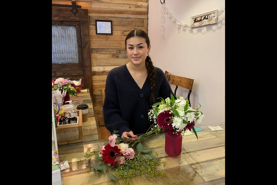 Nicole Doiron is cleaning up her Artisan Gift and Flowers shop on Austin Avenue the day after two men broke in.