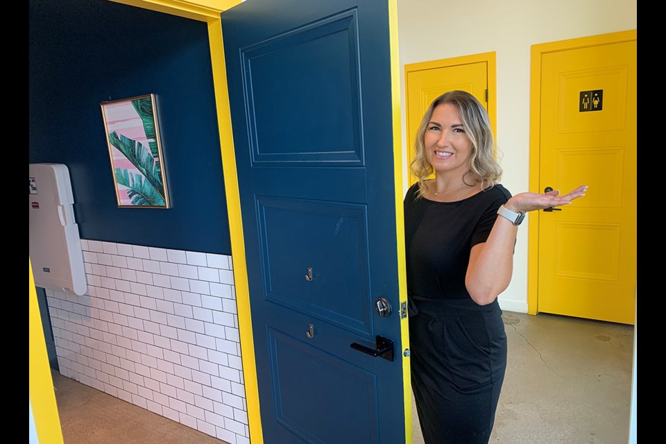 Heather Rhodes, of The Hard Bean Brunch Co., shows off one of her restaurants individual restroom stalls that have been voted the best restrooms in Canada.
