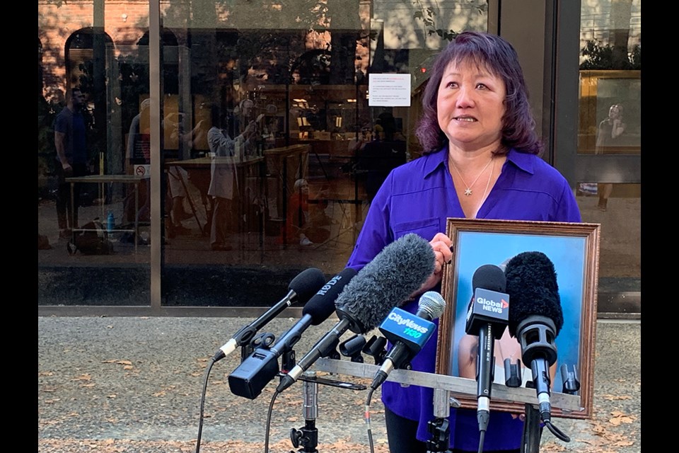 Carol Todd with a photo of her daughter, Amanda, at BC Supreme Court in New Westminster on Oct. 14, 2022. She's noticeably tears up following a judge's decision to sentence Amanda's tormentor to 13 years in prison.