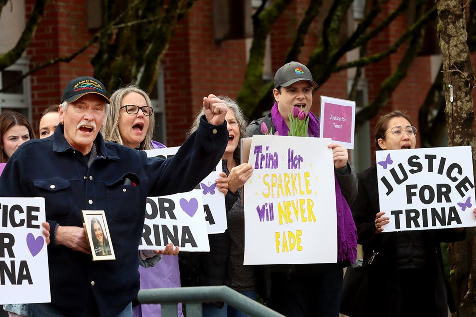 Supporters of murder victim Trina Hunt react to the honk from a passing motorist during a rally at BC Provincial Court in Port Coquitlam Wednesday.