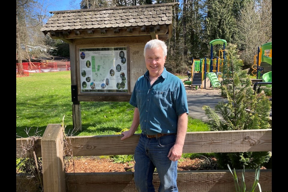 Dave Irving, president of the Oakdale Neighbourhood Association, with a sign the group built to show local spots of interest.