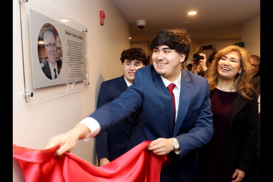 A plaque honouring the namesake of Robert Nicklin Place, a new rental building in Coquitlam, is unveiled by his family, sons Keven and Steven and his wife, Zuly. Nicklin was the CEO of the Affordably Housing Society for 27 years until he died in 2016.