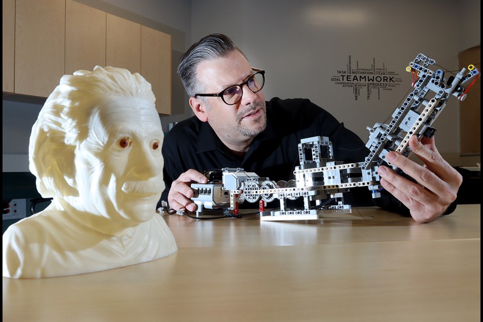 Terry Fox Secondary School teacher Edward Csuka checks out student projects in robotics and 3-D printing. He is receiving an award for teaching excellence from the Canadian Association of Physicists.