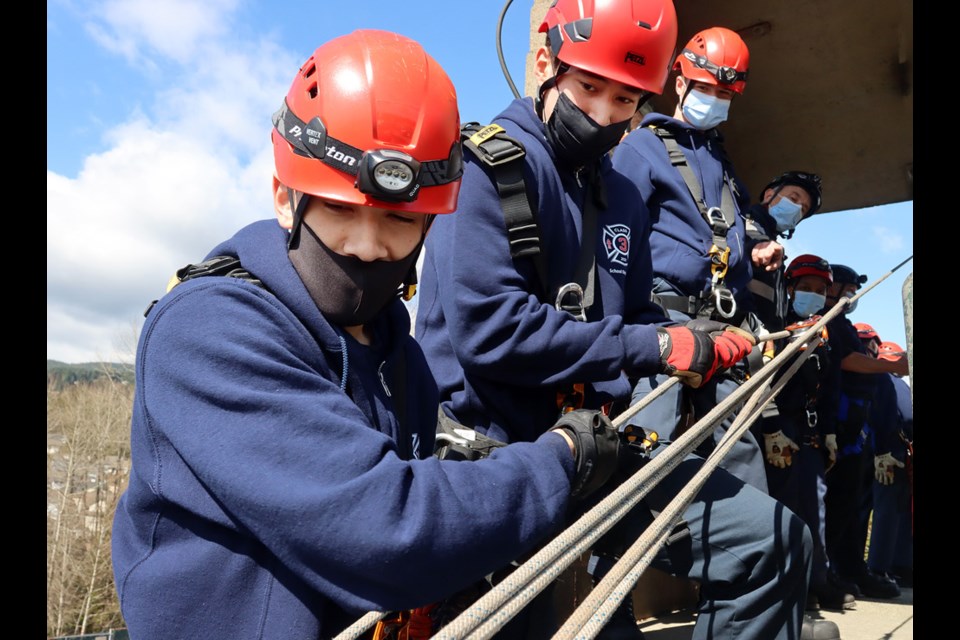 SD43 high school students participating in the 2021 junior firefighter program at Coquitlam Fire Rescue manage safety lines during a high-angle rescue drill.