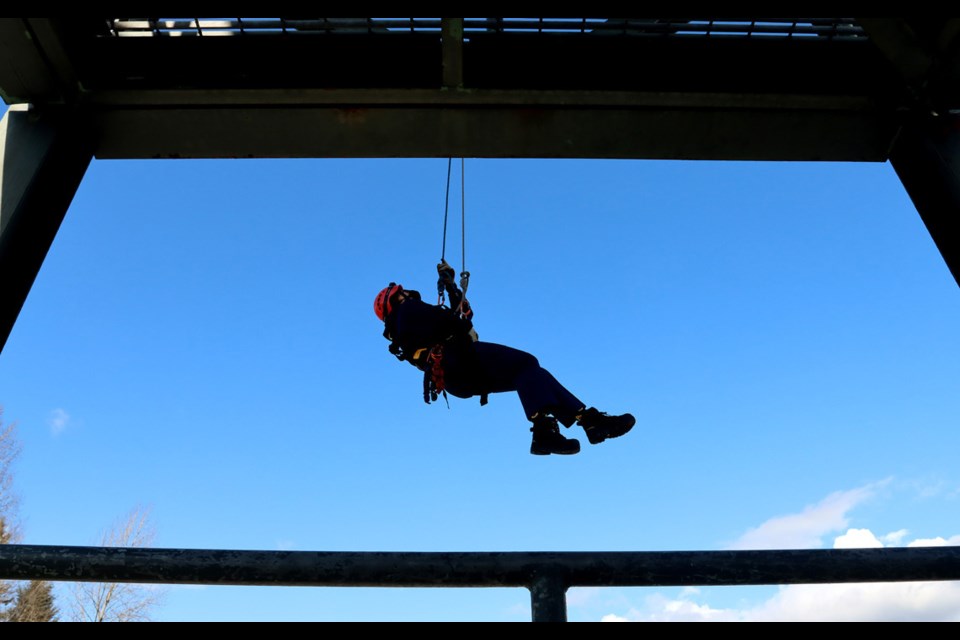 Kiara Burasee, of Gleneagle secondary school, makes her way back to the ground from the training tower at Coquitlam's Town Centre fire hall.