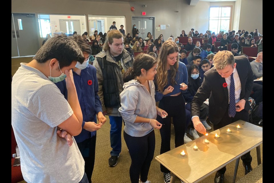 Coquitlam students light six candles to commemorate the Jews who died in the Holocaust.