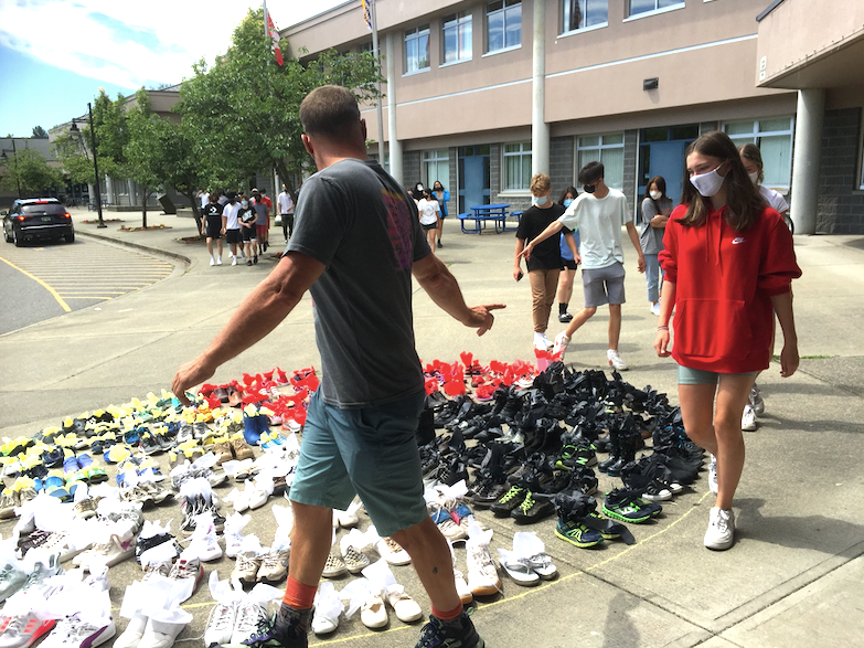 Students in Mike Gosselin’s Grade 10 social studies class visit a medicine wheel display out front of Riverside Secondary in Port Coquitlam as part of a commemoration of the 215 children whose remains were found outside a Kamloops residential school.