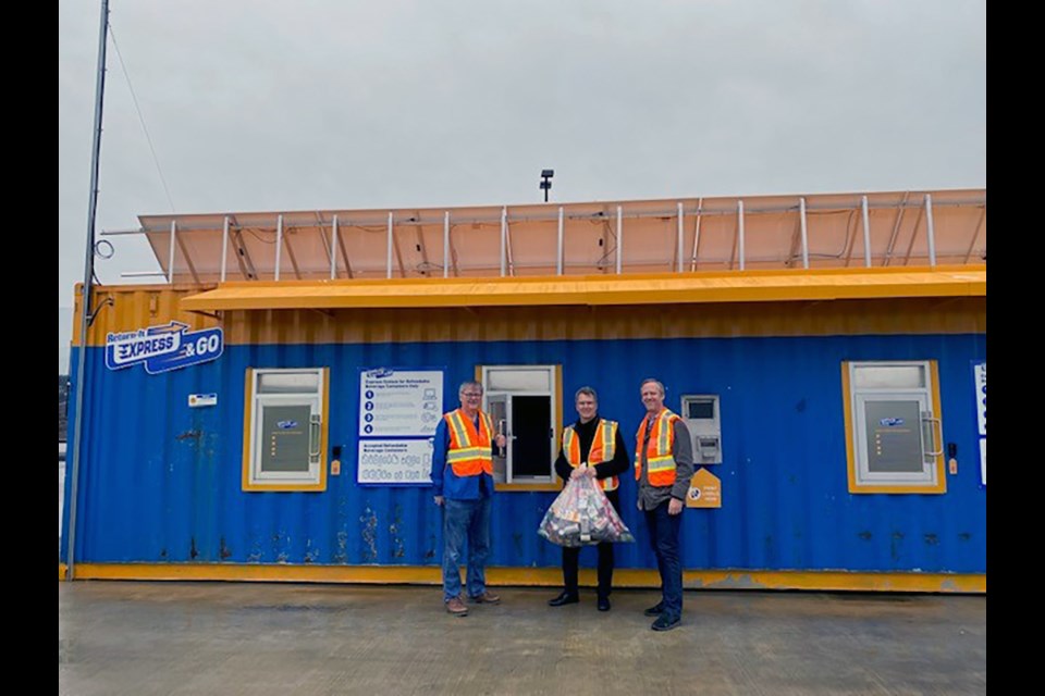[From right to left] Port Moody-Coquitlam MLA Rick Glumac and Coquitlam-Burke Mountain MLA Fin Donnelly test out the new Express & GO station, alongside Return-It interim president and CEO John Nixon, set up at the United Boulevard Recycling and Waste Centre, which opened March 14, 2022.