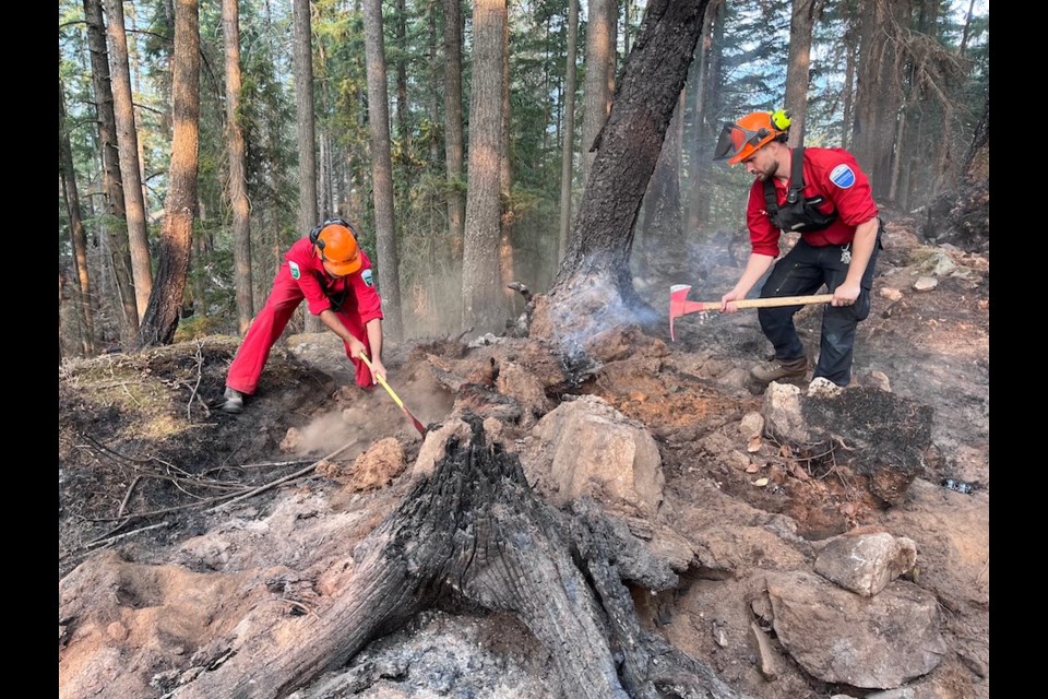 Firefighters work to stop the October, 2022 wildfire at Minnekhada Regional Park.