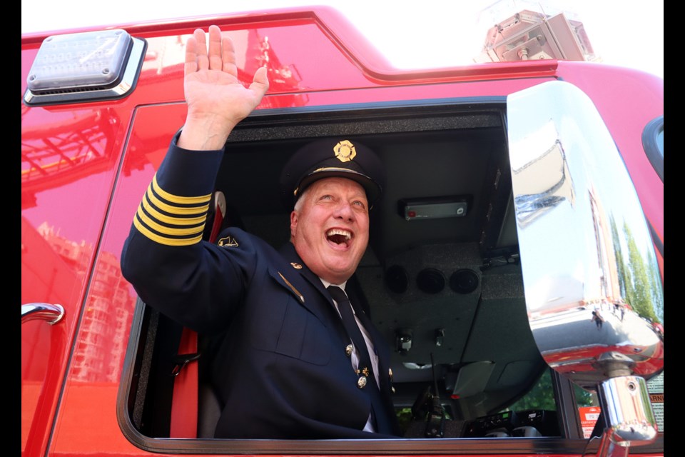 Retiring Port Moody fire chief, Ron Coulson, rides off into the sunset in a ceremonial last ride in one of the department's fire engines at the conclusion of a special "walking out" ceremony on Thursday at Inlet Station.