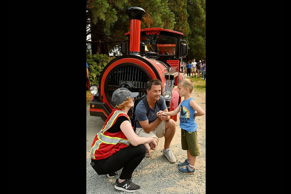 All aboard the new PNE Express Train. Engineer Laura welcomes Greg Cetmarowski and son Eric, 4, from Coquitlam on opening day. 