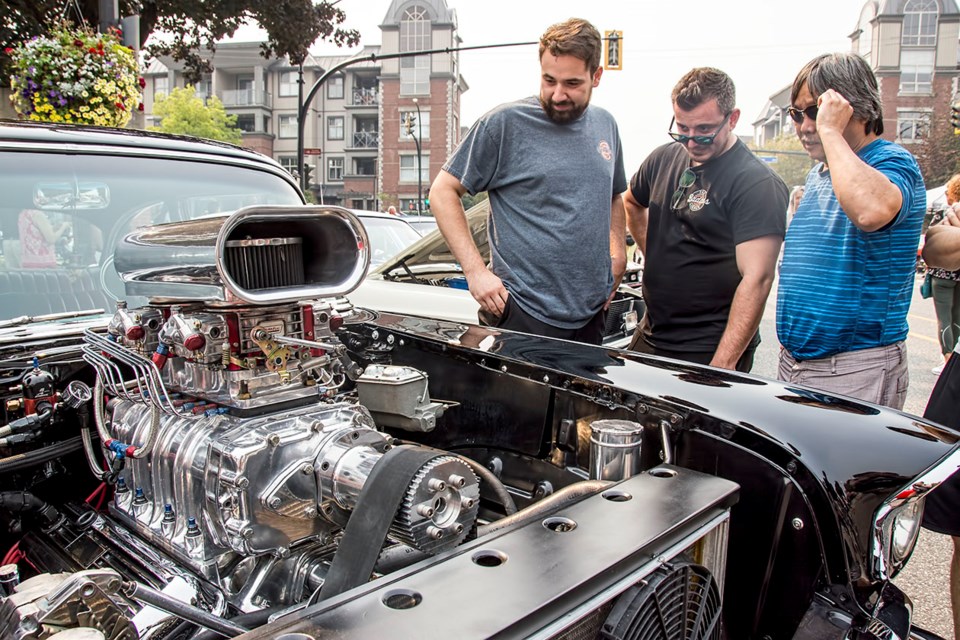 Metro Ford Downtown Port Coquitlam Car Show visitors check out the shiny engine of a 1972 Chevy on Aug. 20, 2023. | Chung Chow, Tri-City News