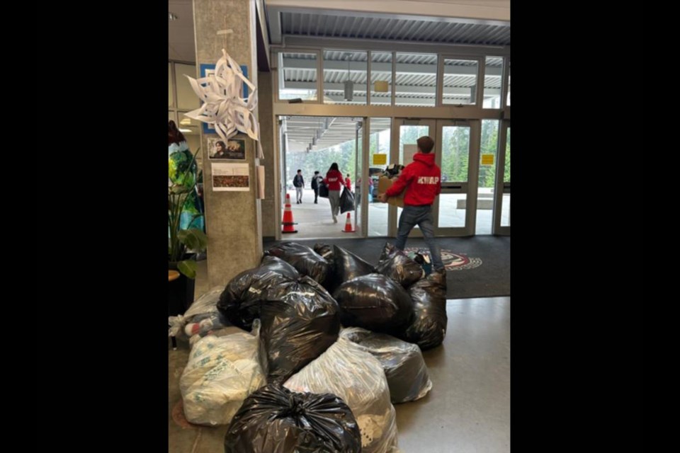 Heritage Woods Secondary students part of Kodiaks with a Purpose (KWAP) collected and delivered dozens of bags of winter clothing items to those utilizing services at 3030 Gordon Ave. in Coquitlam on Dec. 15, 2023.