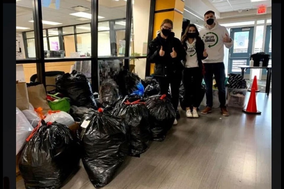 UpLift Canada Foundation members collect bags of donated clothes as part of the non-profit's goal to preach social justice and inclusivity.