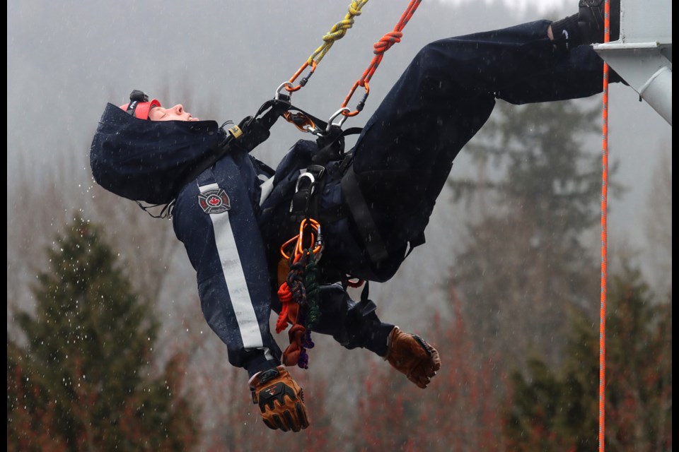 Scott McLeod begins his descent during high-angle rescue training at Coqutilam's Fire Rescue's annual junior firefighter academy.