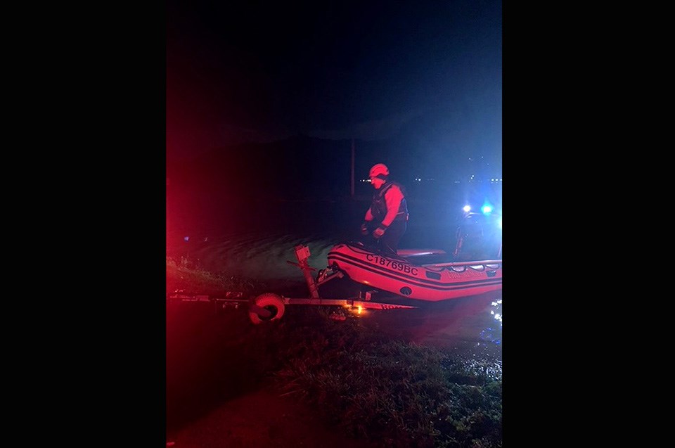 A marine crew from Port Moody Fire Rescue launches its Zodiac in Abbotsford's Sumas Prairie where it was dispatched to help rescue residents stranded by rising flood waters the night of Nov. 16, 2021. The team helped get five adults and a large dog to safety.