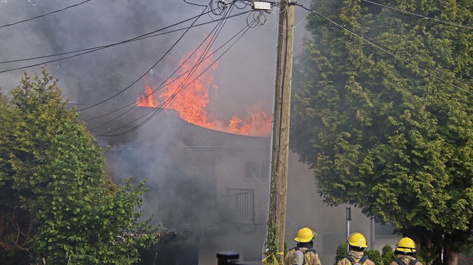 Coquitlam firefighters battle the flames of a Therrien Street home blaze near Brunette Avenue on June 10, 2021.