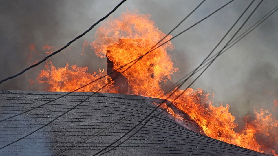 Coquitlam firefighters battle the flames of a Therrien Street home blaze near Brunette Avenue on June 10, 2021.
