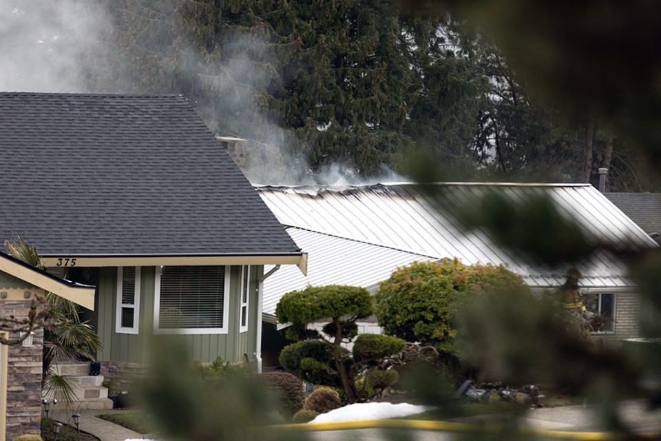 Firefighters responded to a house fire on Dartmoor Drive in southwest Coquitlam on March 8, 2023.