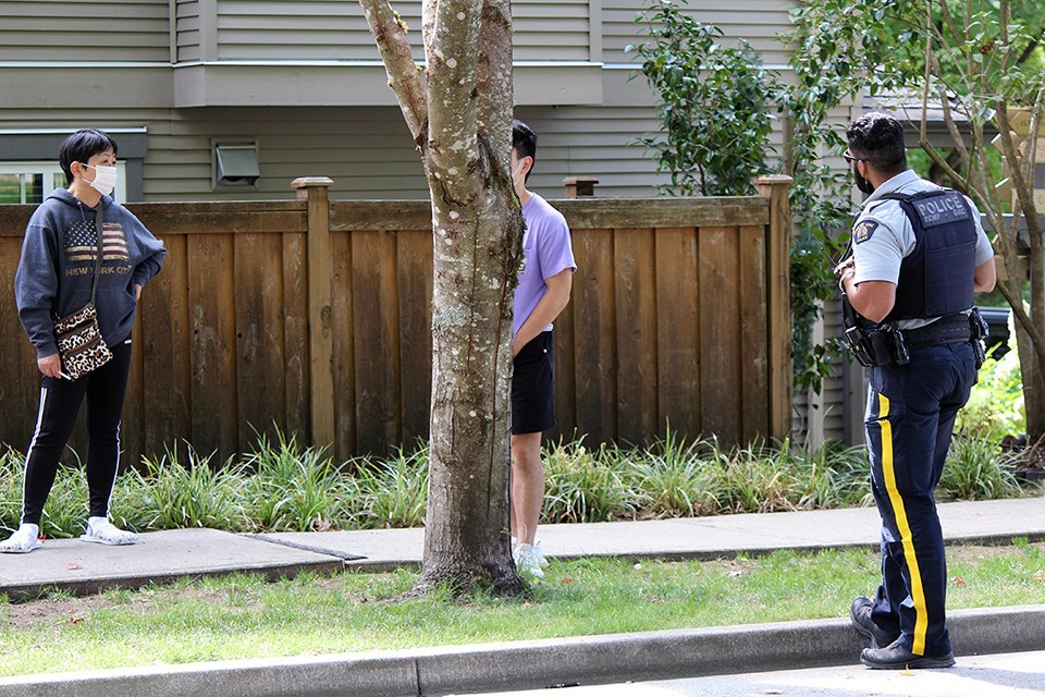 Coquitlam RCMP speak with witnesses and McTavish Court neighbours as they investigate a deceased body found in a home following a fire on Sept. 8, 2021.