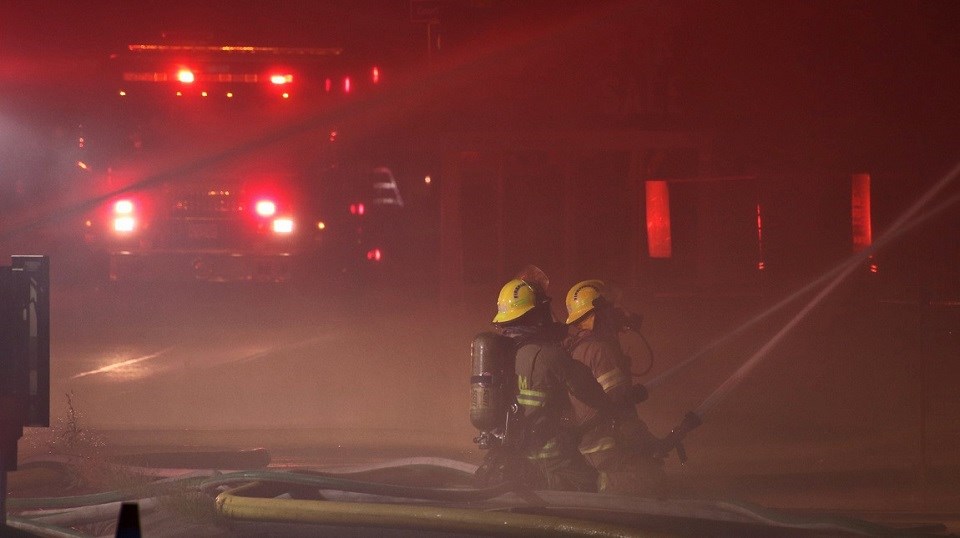 Port Coquitlam Fire Rescue trying to extinguish a blaze in a Kingsway Avenue business plaza during the early hours of Aug. 3, 2021.