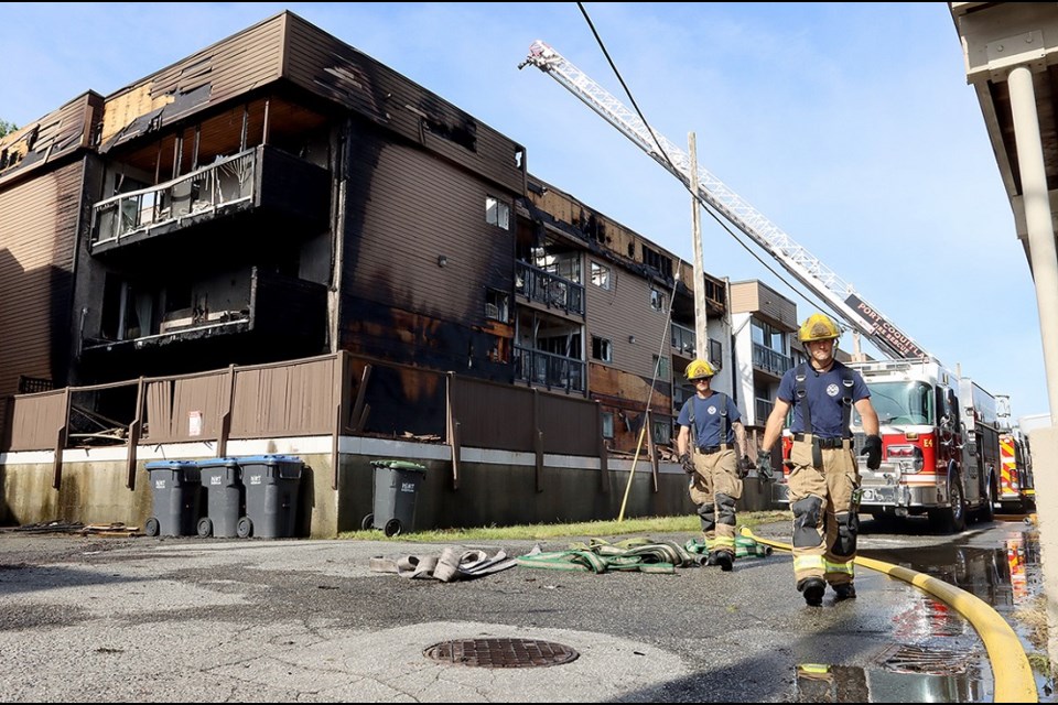 Port Coquitlam firefighters continue their mop-op operations at the scene of a large apartment fire at 2245 Wilson Ave. from June 25, 2022.