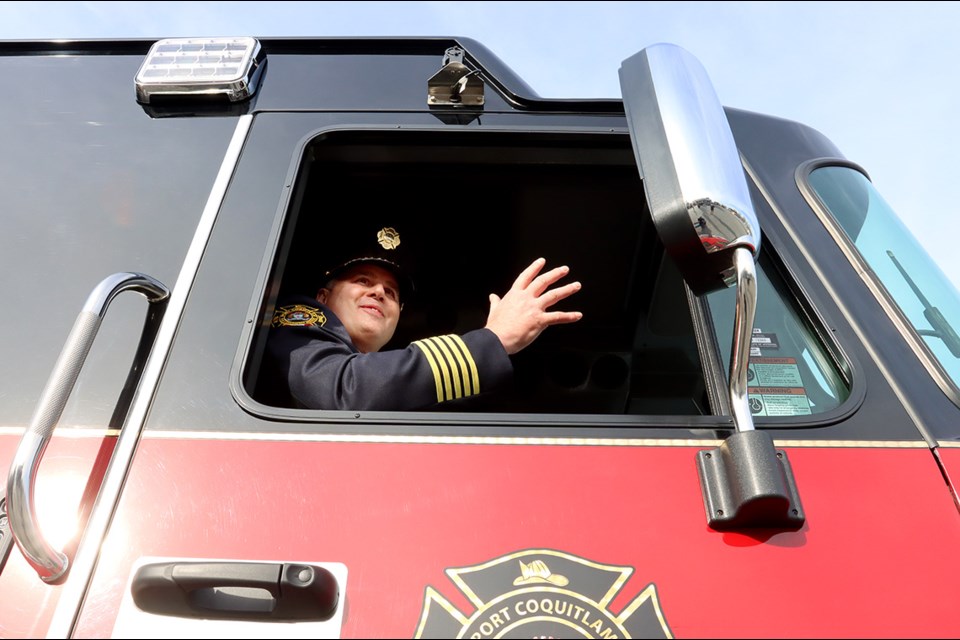 Retiring Port Coquitlam fire chief Robert Kipps waves farewell.