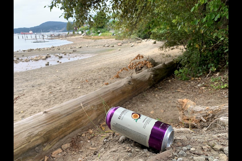A discarded cider can sits at the walkway to the west beach at Port Moody's Old Orchard Park. A frequent user of the park says signs about the city's new pilot program to allow alcohol consumption in seven public spaces is confusing, implying booze is allowed in the secluded area when in fact its allowed in other parts of the park but not there.