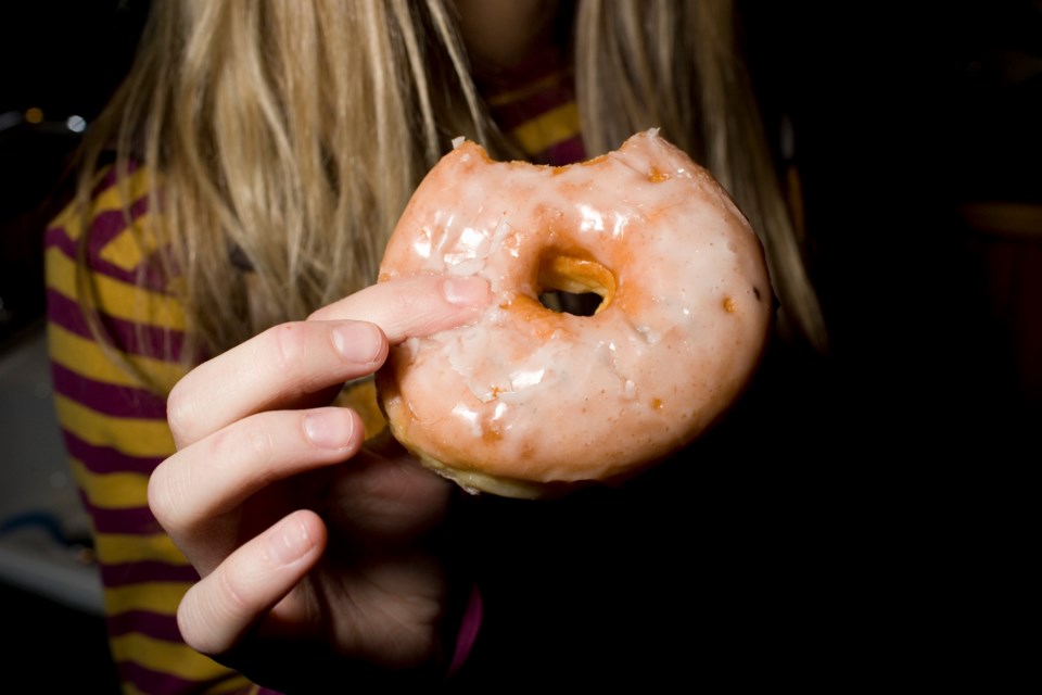 Teen eating a dougnut