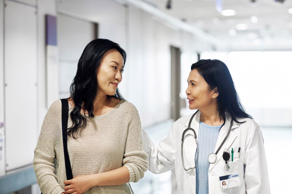 doctor-talking-with-patient-in-hallway-getty-image