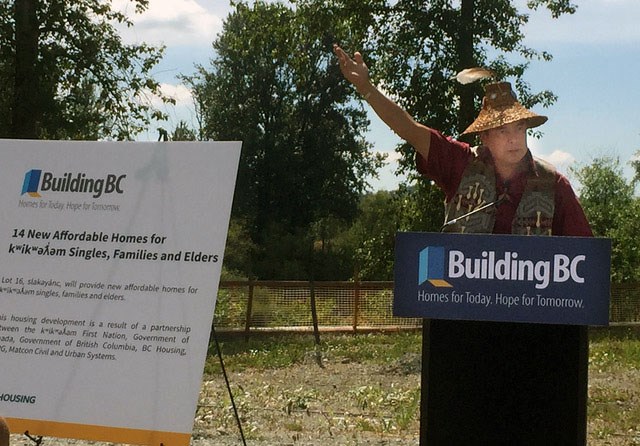 Kwikwetlem First Nation Chief Ed Hall stands at the podium during a blessing ceremony for a 14-unit housing development by the Coquitlam River on Aug. 10, 2021.