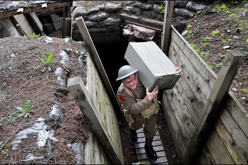Markus Fahrner, a former coordinator at the Port Moody Station Museum, trudges equipment through the McKnight trench to demonstrate some of the challenges trench life presented to soldiers in WWI. The trench, which was first constructed in 2014 to commemorate the 100th anniversary of the start of WWI, is to be decommissioned and filled in.
